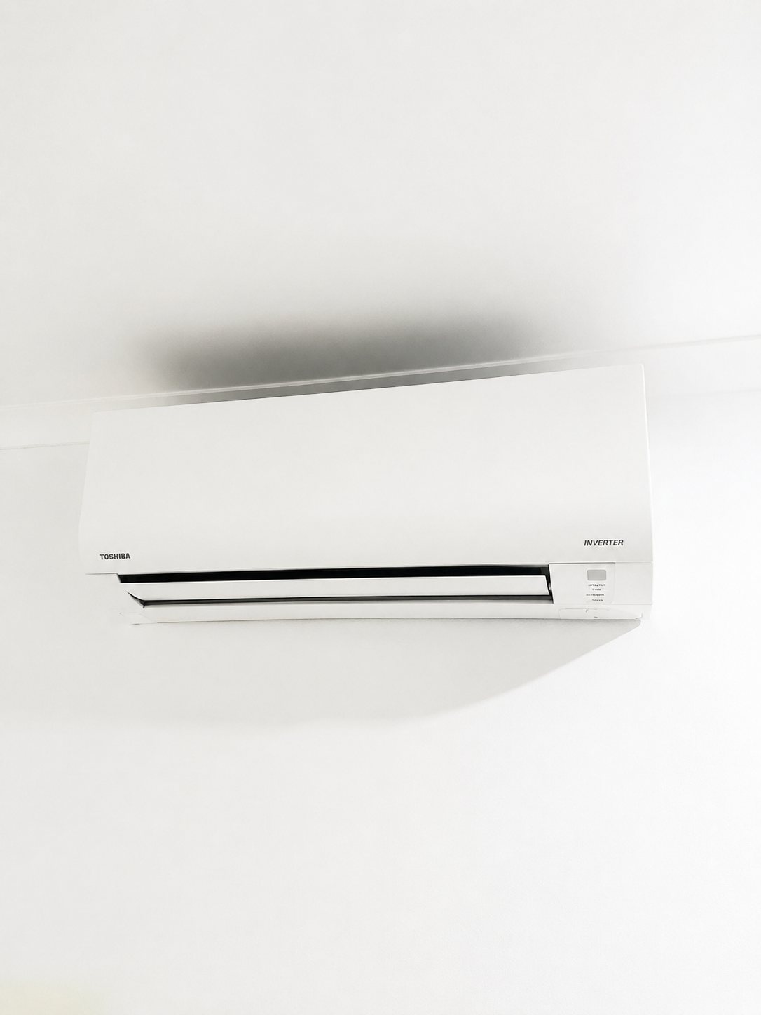 Toshiba inverter split system head mounted on a clean white wall